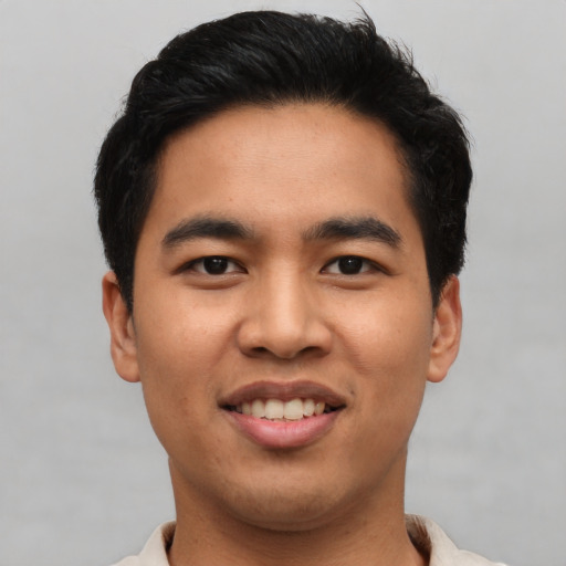 Joyful asian young-adult male with short  black hair and brown eyes