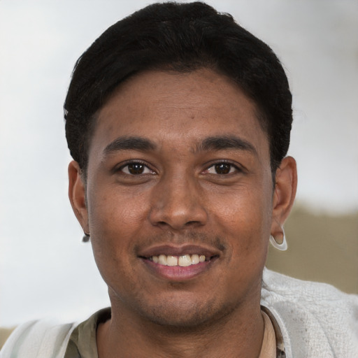 Joyful black young-adult male with short  brown hair and brown eyes