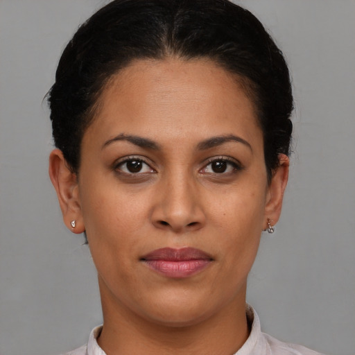 Joyful latino young-adult female with short  brown hair and brown eyes