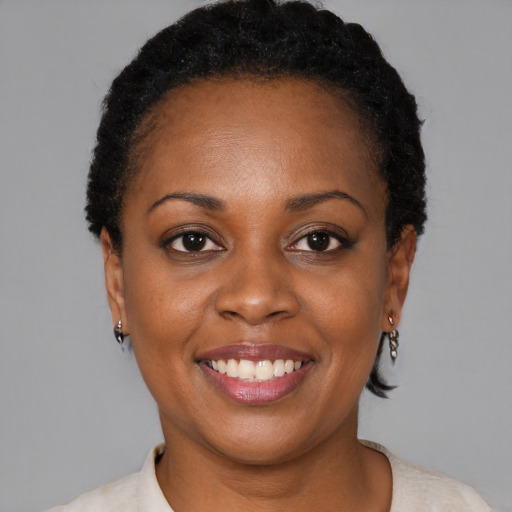 Joyful black young-adult female with short  brown hair and brown eyes