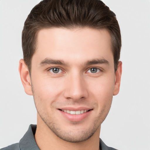 Joyful white young-adult male with short  brown hair and brown eyes