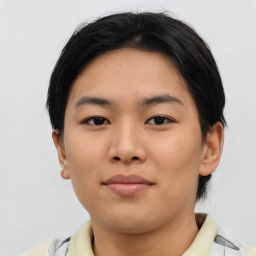 Joyful asian young-adult female with short  brown hair and brown eyes