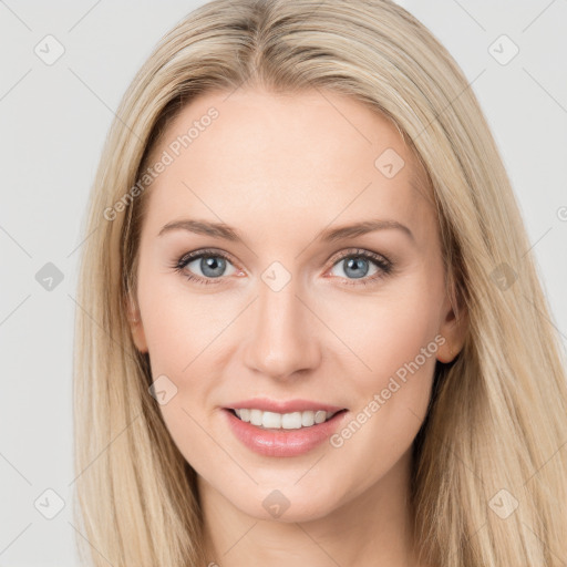 Joyful white young-adult female with long  brown hair and blue eyes