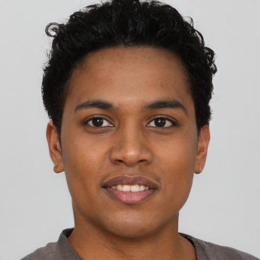Joyful black young-adult male with short  black hair and brown eyes
