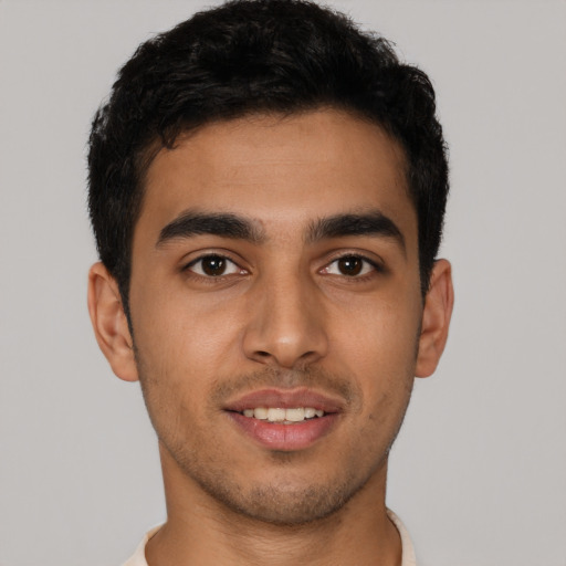 Joyful latino young-adult male with short  brown hair and brown eyes