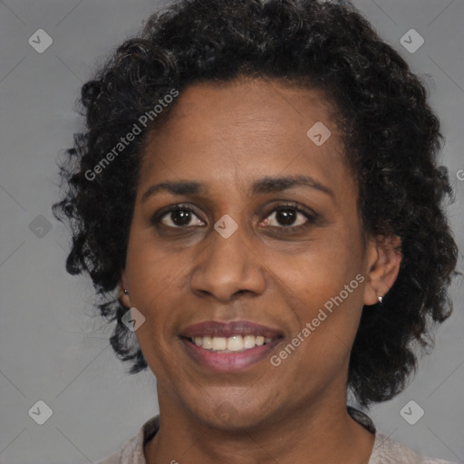 Joyful black adult female with medium  brown hair and brown eyes