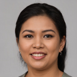 Joyful latino young-adult female with medium  brown hair and brown eyes