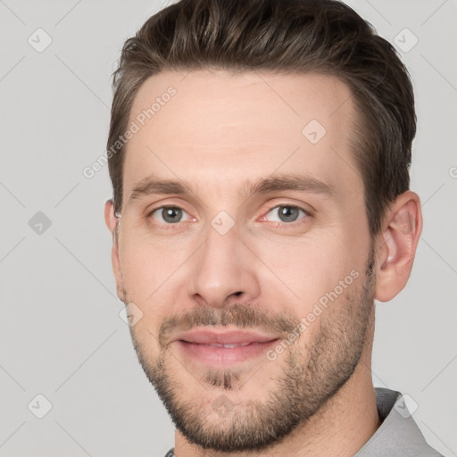 Joyful white young-adult male with short  brown hair and brown eyes