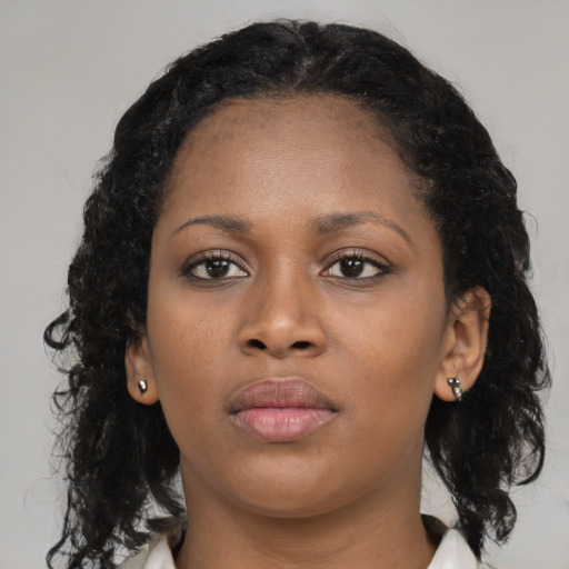 Neutral black young-adult female with medium  brown hair and brown eyes