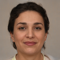 Joyful white young-adult female with medium  brown hair and brown eyes