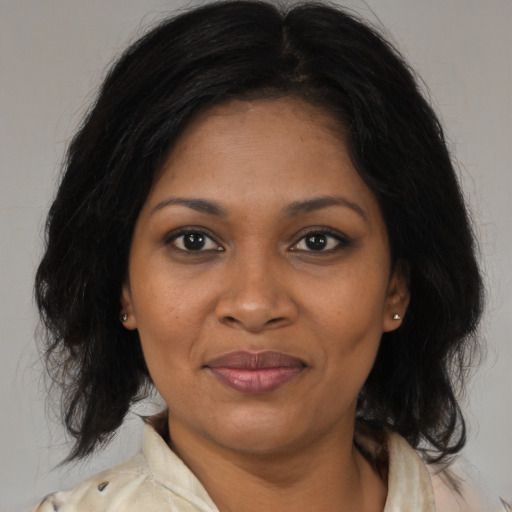 Joyful black young-adult female with medium  brown hair and brown eyes
