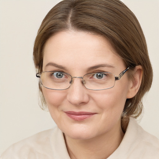 Joyful white young-adult female with medium  brown hair and green eyes