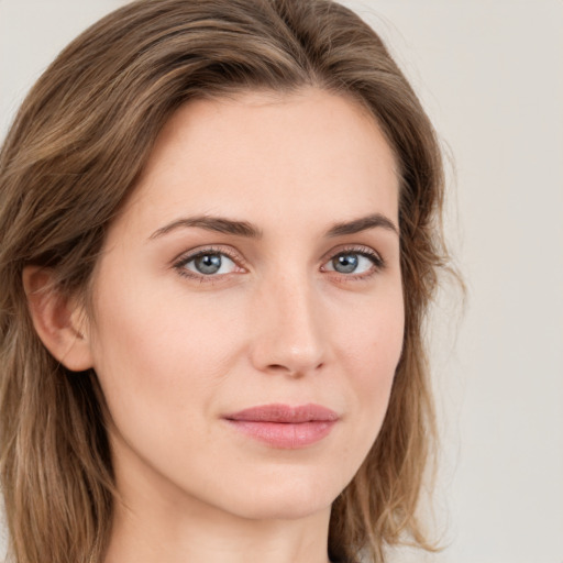 Joyful white young-adult female with long  brown hair and green eyes