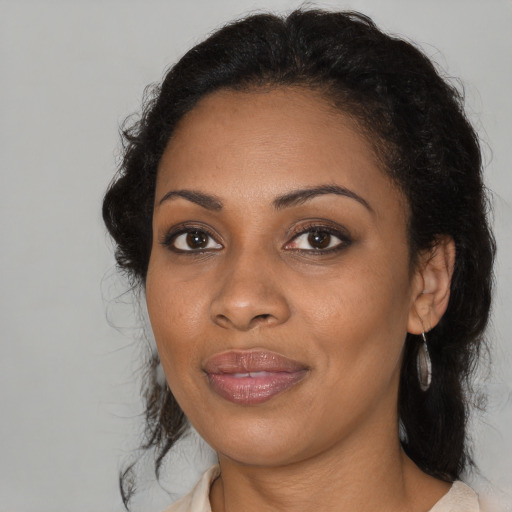 Joyful black young-adult female with medium  brown hair and brown eyes