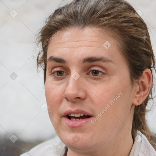 Joyful white adult female with medium  brown hair and brown eyes