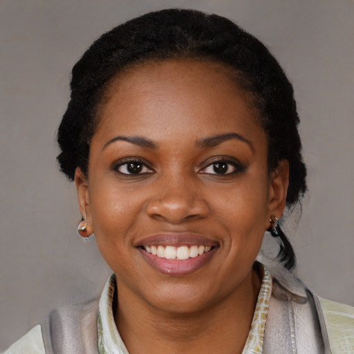 Joyful black young-adult female with short  black hair and brown eyes