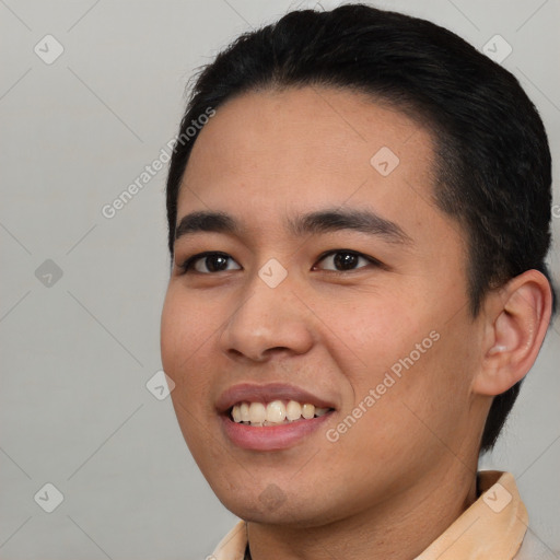 Joyful asian young-adult male with short  black hair and brown eyes