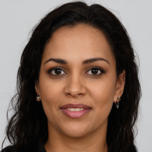 Joyful latino young-adult female with long  brown hair and brown eyes