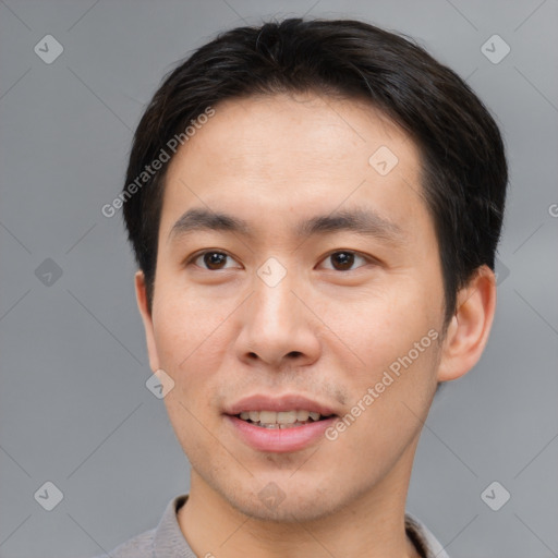 Joyful asian young-adult male with short  brown hair and brown eyes