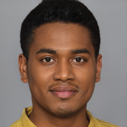 Joyful black young-adult male with short  brown hair and brown eyes