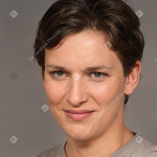 Joyful white adult female with short  brown hair and grey eyes