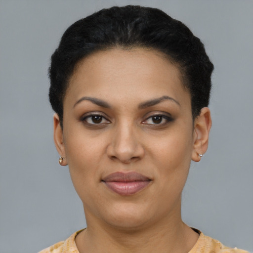 Joyful latino young-adult female with short  black hair and brown eyes