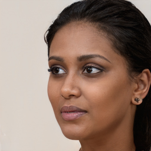 Neutral black young-adult female with long  brown hair and brown eyes