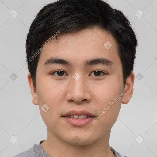 Joyful asian young-adult male with short  brown hair and brown eyes