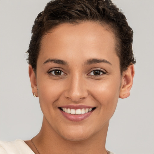 Joyful white young-adult female with short  brown hair and brown eyes