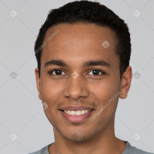 Joyful white young-adult male with short  black hair and brown eyes