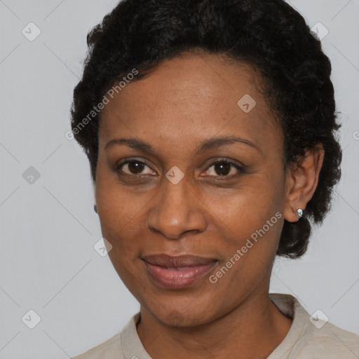 Joyful black adult female with short  black hair and brown eyes