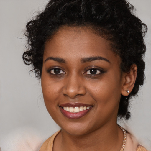 Joyful black young-adult female with long  brown hair and brown eyes