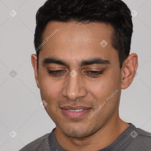 Joyful white young-adult male with short  black hair and brown eyes