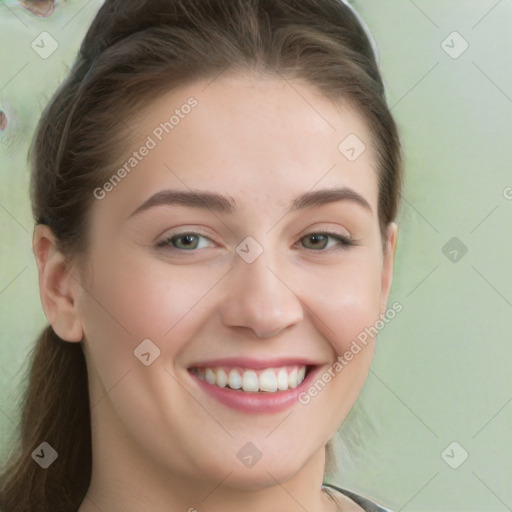 Joyful white young-adult female with long  brown hair and green eyes