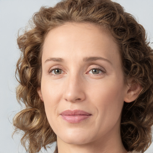 Joyful white young-adult female with medium  brown hair and green eyes