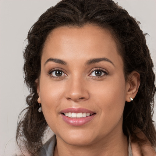 Joyful white young-adult female with long  brown hair and brown eyes