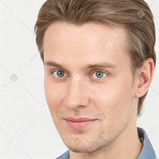 Joyful white young-adult male with short  brown hair and grey eyes