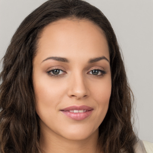 Joyful white young-adult female with long  brown hair and brown eyes