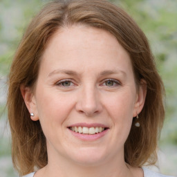 Joyful white adult female with medium  brown hair and grey eyes