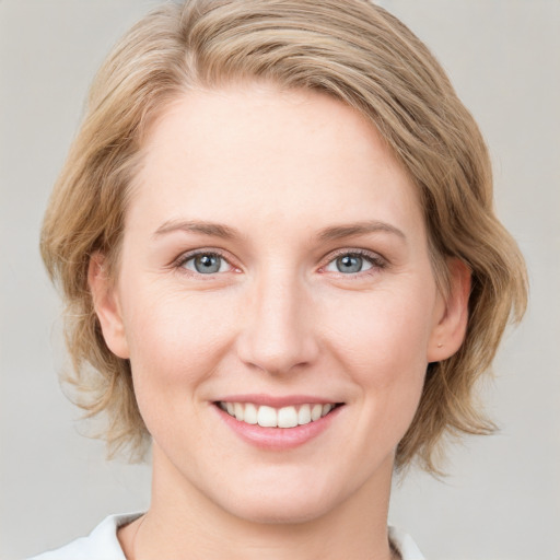 Joyful white young-adult female with medium  brown hair and blue eyes