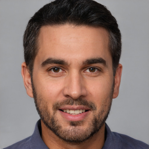 Joyful white young-adult male with short  brown hair and brown eyes