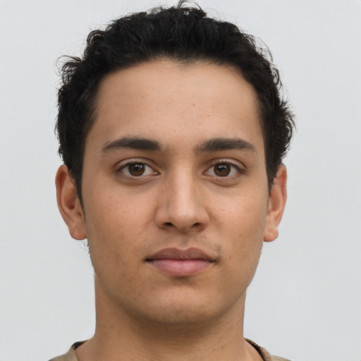 Neutral latino young-adult male with short  brown hair and brown eyes