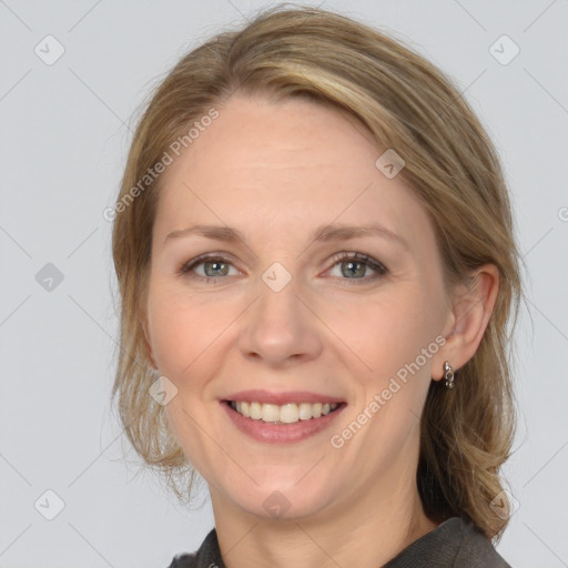 Joyful white adult female with medium  brown hair and grey eyes