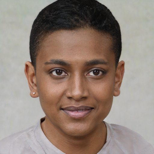 Joyful black young-adult male with short  black hair and brown eyes