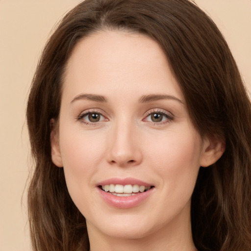 Joyful white young-adult female with long  brown hair and green eyes