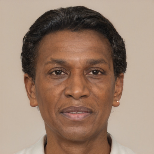 Joyful black adult male with short  black hair and brown eyes