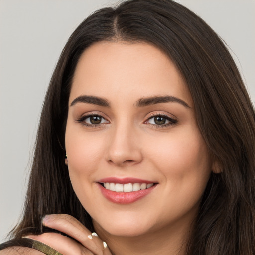 Joyful white young-adult female with long  brown hair and brown eyes