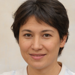 Joyful white adult female with medium  brown hair and brown eyes