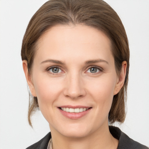 Joyful white young-adult female with medium  brown hair and grey eyes