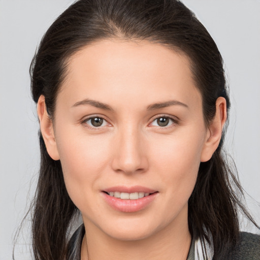 Joyful white young-adult female with long  brown hair and brown eyes